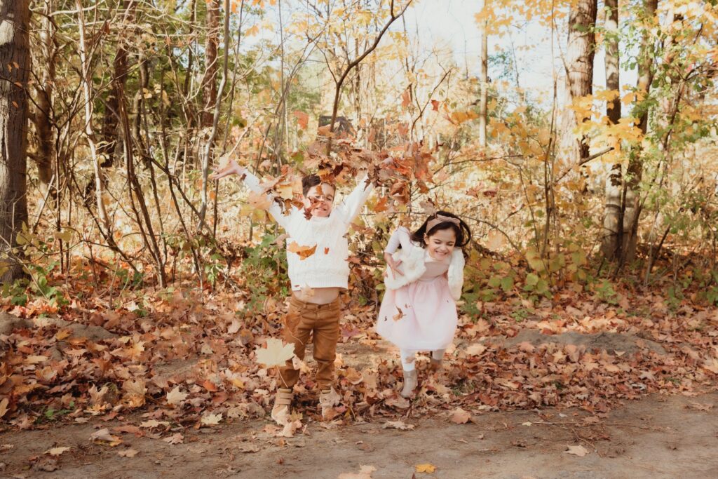 brother and sister fall leaves portrait