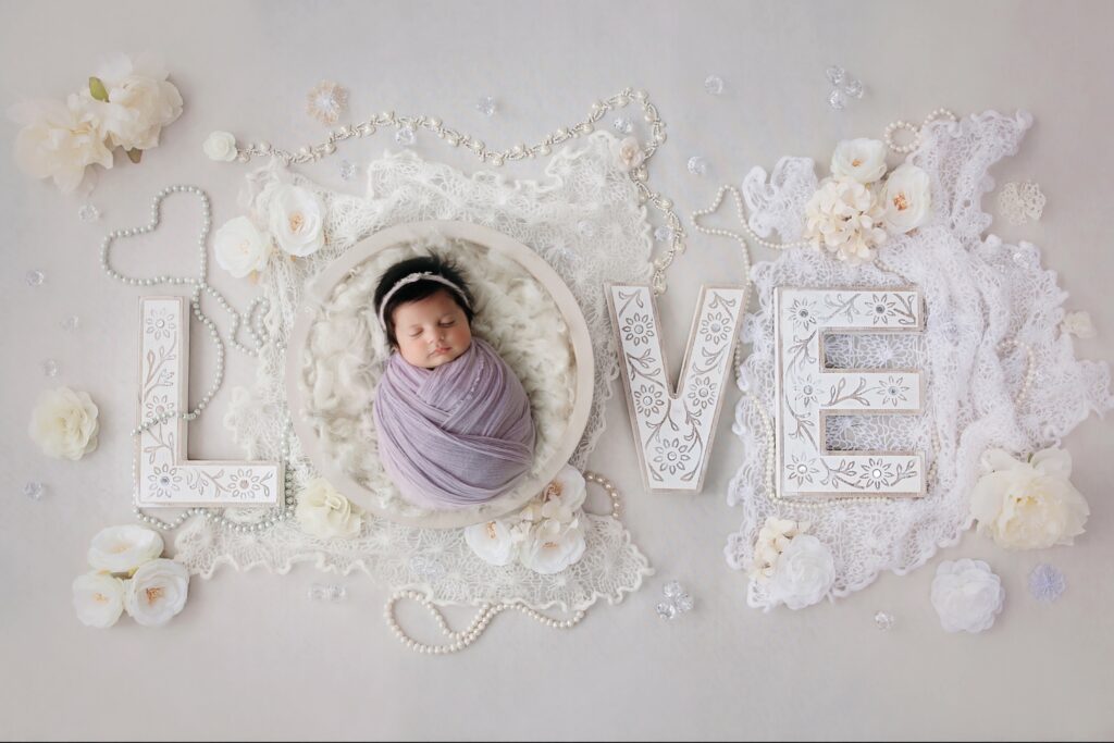 baby laid out in the word love