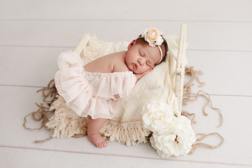 baby girl sleeping on mini bed