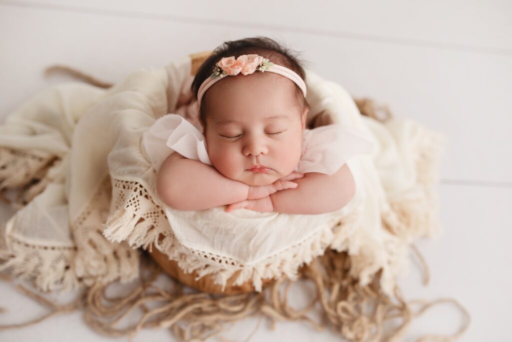 baby sleeping in yarn basket
