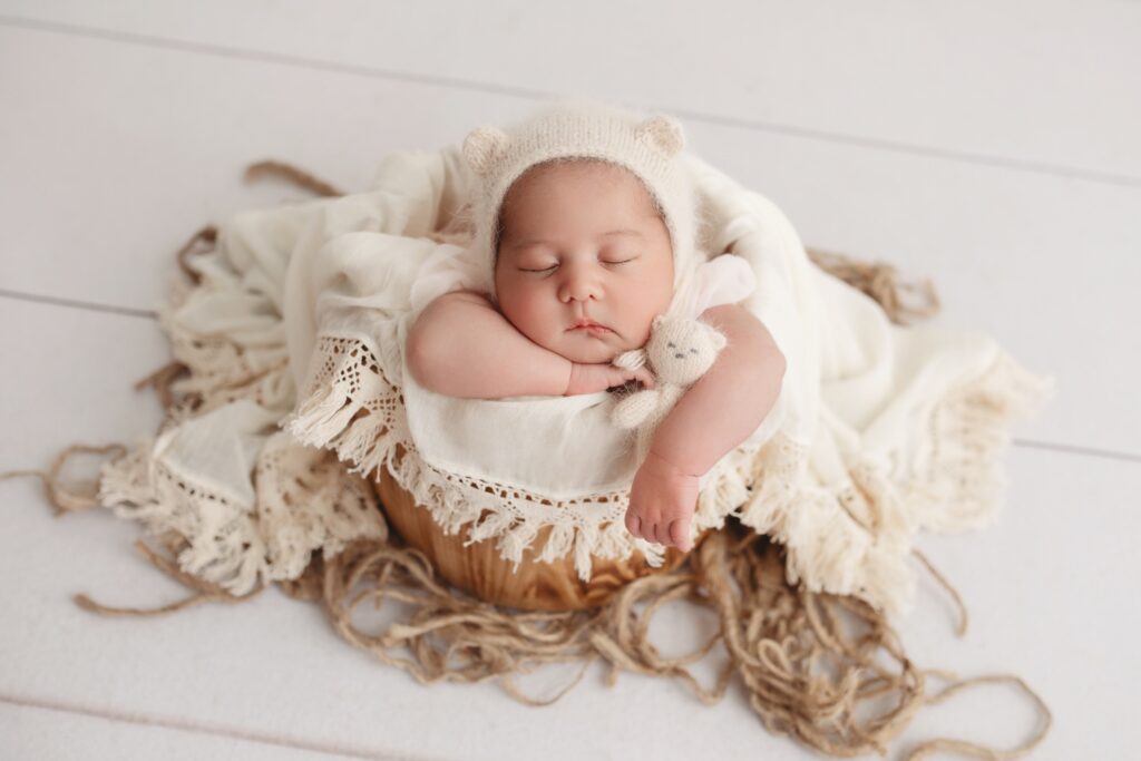 baby sleeping in yarn basket