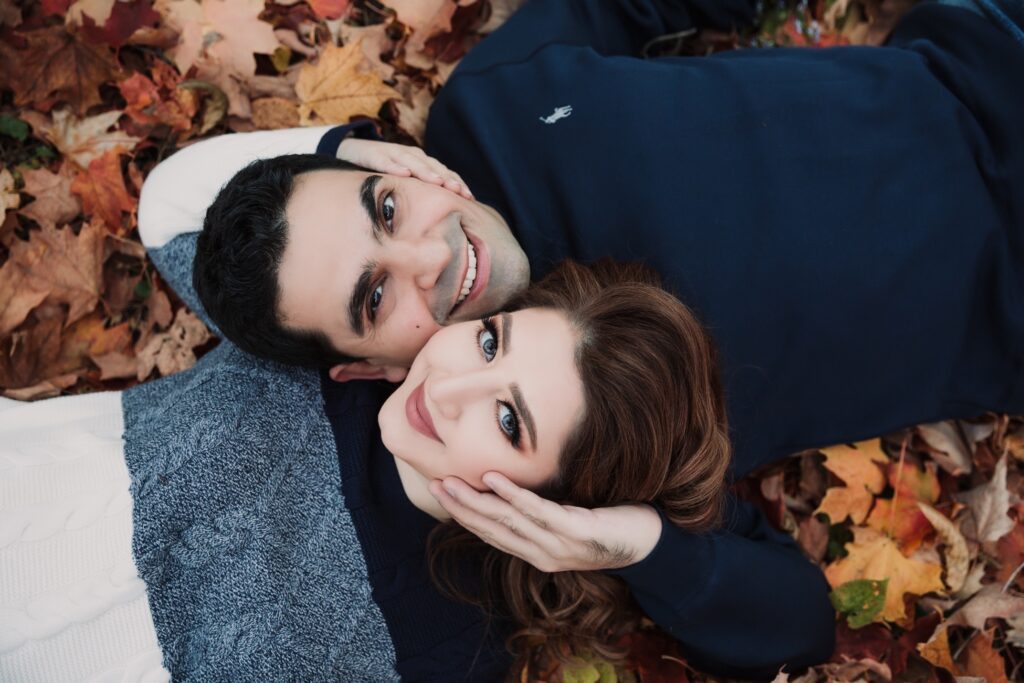 couple laying in leaves