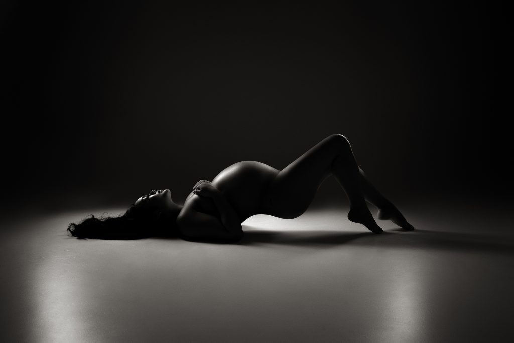 elegant studio maternity portrait at 30 weeks in Toronto with dramatic lighting